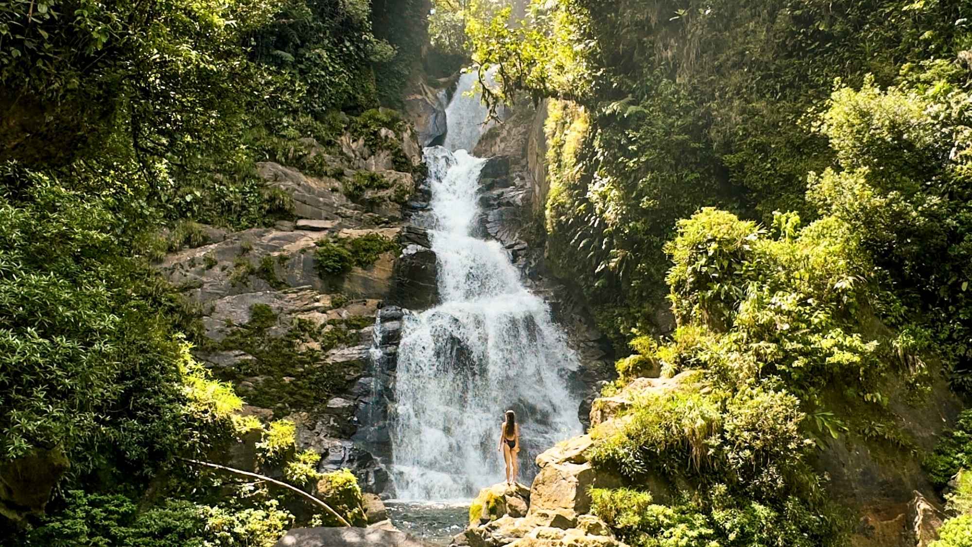 a person standing in front of Escobal y Escobalito waterfalls